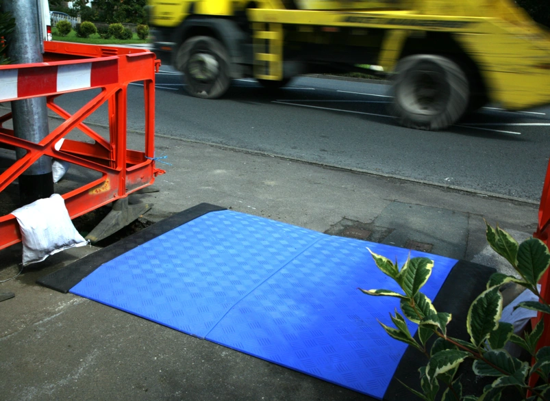 Blue Trench Plate on a busy pedestrian path works