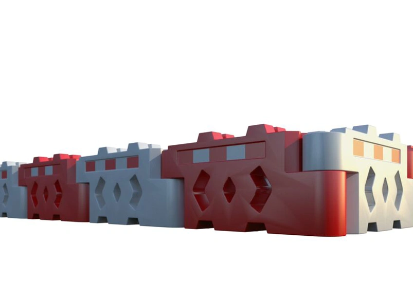 Row of interlocking red and white water-filled traffic barriers