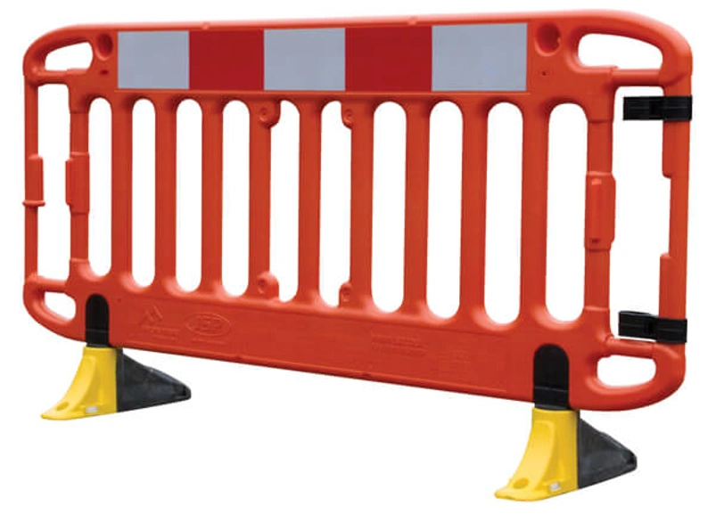 Single orange plastic pedestrian safety barrier with reflective panels and yellow feet